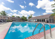 Thumbnail 1 of 23 - Outdoor swimming pool with seating at Woodbridge Apartments