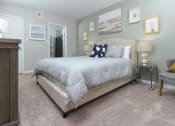 Thumbnail 10 of 39 - Spacious master bedroom, featuring furnishings at Woods of Fairfax.