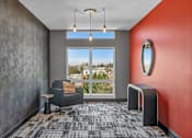 Thumbnail 14 of 37 - Resident lounge with seating and large windows at The Lyric Apartments, Seattle, Washington
