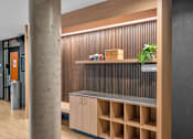 Thumbnail 24 of 37 - Built in shelving unit with wood slat backdrop at The Lyric Apartments, Washington