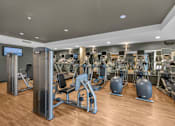 Thumbnail 9 of 37 - Fitness center with cardio and strength equipment at The Lyric Apartments, Washington, 98102