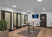Thumbnail 8 of 37 - Collaborative workspace with high top table and privacy booths at The Lyric Apartments, Seattle, WA 98102