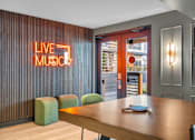 Thumbnail 21 of 37 - Recreation room with ping pong table and neon sign at The Lyric Apartments, Washington