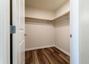 Thumbnail 29 of 37 - Walk-in closet with hardwood flooring and hanging rods at The Lyric Apartments, Washington