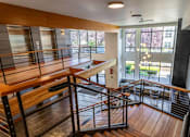 Thumbnail 12 of 37 - Multilevel lobby with wood accents and modern railings at The Lyric Apartments, Seattle, WA 98102