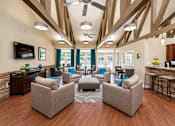 Thumbnail 2 of 29 - A living room with a brown wooden floor and a ceiling fan.