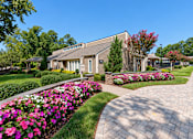 Thumbnail 1 of 29 - A residential building with a garden in front.