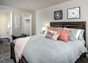 Thumbnail 28 of 29 - A bedroom with a large bed and two wall art pieces.