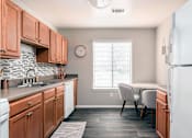 Thumbnail 20 of 29 - A kitchen with wooden cabinets and a white refrigerator.