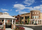 Thumbnail 1 of 15 - Liberty Landing Front Entrance with Gazebo, white wooden pergola and tan buildings.