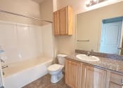 Thumbnail 10 of 18 - Liberty Bend Townhome Apartments, Sandy, Utah bathroom with a sink toilet and bath tub