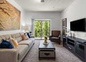 Thumbnail 2 of 34 - Living room with balcony and modern furnishings at Liberty Gateway Apartments, Salt Lake City