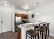 Thumbnail 3 of 34 - Open kitchen with breakfast bar and pendant lighting at Liberty Gateway Apartments, Utah, 84101