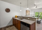 Thumbnail 6 of 34 - Kitchen island with granite countertop and dishwasher at Liberty Gateway Apartments, Salt Lake City, UT