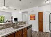 Thumbnail 5 of 34 - Kitchen featuring granite counters and wood cabinetry at Liberty Gateway Apartments, Salt Lake City, 84101