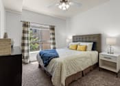 Thumbnail 8 of 34 - Bedroom with upholstered headboard and natural light at Liberty Gateway Apartments, Salt Lake City, Utah