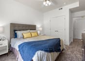 Thumbnail 9 of 34 - Bedroom with tufted headboard and closet doors at Liberty Gateway Apartments, Salt Lake City