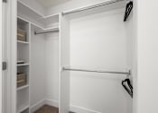 Thumbnail 13 of 34 - Walk-in closet with shelving and dual rods at Liberty Gateway Apartments, Utah