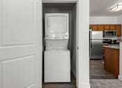 Thumbnail 14 of 34 - Stacked washer and dryer in laundry closet at Liberty Gateway Apartments, Salt Lake City, UT