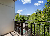 Thumbnail 12 of 34 - Balcony with metal railing overlooking trees at Liberty Gateway Apartments, Salt Lake City, 84101