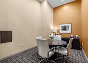 Thumbnail 26 of 34 - Conference room with round table and modern chairs at Liberty Gateway Apartments, Salt Lake City