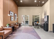 Thumbnail 25 of 34 - Community lounge with dining table and seating at Liberty Gateway Apartments, Utah