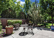 Thumbnail 21 of 34 - Private patio with outdoor dining furniture at Liberty Gateway Apartments, Salt Lake City, UT 84101