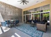 Thumbnail 22 of 34 - Covered patio with seating and ceiling fan at Liberty Gateway Apartments, Salt Lake City, UT