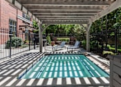 Thumbnail 15 of 34 - Swimming pool under pergola with lounge chairs at Liberty Gateway Apartments, Salt Lake City, 84101