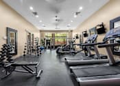 Thumbnail 18 of 34 - Fitness center with cardio equipment and free weights at Liberty Gateway Apartments, Salt Lake City