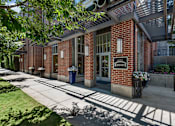 Thumbnail 28 of 34 - Brick building entrance with library signage at Liberty Gateway Apartments, Utah