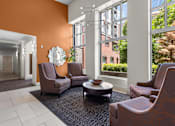 Thumbnail 24 of 34 - Welcoming lobby with contemporary seating and orange accent wall at Liberty Gateway Apartments, Salt Lake City, UT 84101