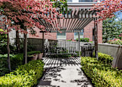 Thumbnail 20 of 34 - Garden courtyard with pergola and seating area at Liberty Gateway Apartments, Salt Lake City, UT