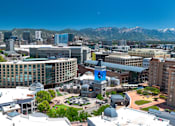 Thumbnail 30 of 34 - Aerial view of downtown urban skyline with mountains at Liberty Gateway Apartments, Salt Lake City, 84101