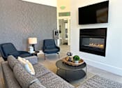Thumbnail 19 of 21 - Modern lounge with fireplace and seating at Liberty Point Apartments, Utah