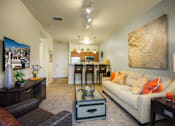 Thumbnail 5 of 22 - Liberty Gateway Apartments, Salt Lake City, Utah, A living room with a couch, coffee table, and a painting on the wall.