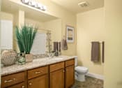 Thumbnail 7 of 22 - Liberty Gateway Apartments, Salt Lake City, Utah, A bathroom with a toilet, sink, and mirror.