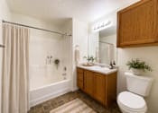 Thumbnail 18 of 20 - Liberty Landing Apartments, West Jordan, UT, bathroom with a toilet, sink, and shower.