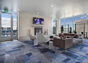 Thumbnail 19 of 41 - A modern living room with a television and comfortable seating.