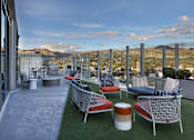Thumbnail 24 of 41 - A patio with chairs and a table with a view of the mountains.