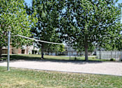 Thumbnail 17 of 23 - A volleyball net is set up in a grassy area.