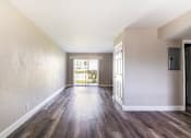 Thumbnail 3 of 19 - an empty living room with wood flooring and a door to a balconyat Palm Cove Apartments, Daytona Beach Florida