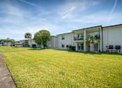 Thumbnail 14 of 19 - the preserve at ballantyne commons yard and apartment buildings at Palm Cove Apartments, Florida