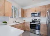 Thumbnail 7 of 29 - kitchen with wooden cabinets and stainless steel appliances