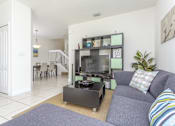 Thumbnail 4 of 29 - a living room with a couch and a table