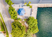 Thumbnail 15 of 15 - an aerial view of a house with a blue umbrella next to a body of water at Lakeside @ Biscayne Gardens,North Miami