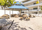 Thumbnail 14 of 15 - a large patio with picnic tables and chairs and a gazebo at Lakeside @ Biscayne Gardens,North Miami, FL,33181