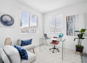 Thumbnail 13 of 29 - a home office with white walls and a glass desk