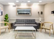 Thumbnail 12 of 15 - a living room with a gray couch and two chairs at Lakeside @ Biscayne Gardens,North Miami, Florida