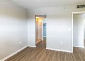 Thumbnail 7 of 15 - a bedroom with hardwood floors and white walls at Lakeside @ Biscayne Gardens,North Miami, Florida,33181